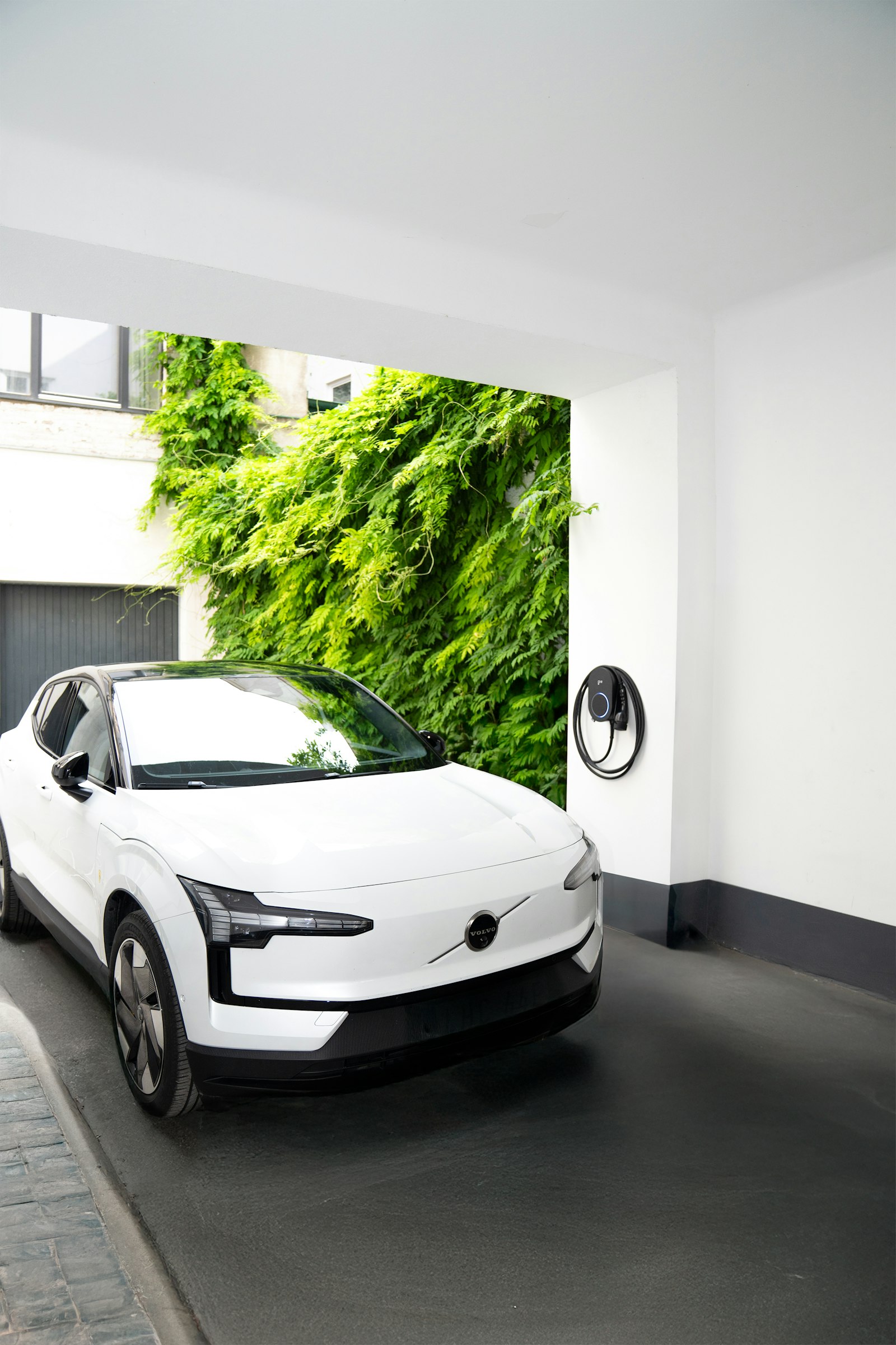 White electric car charging at home wallbox